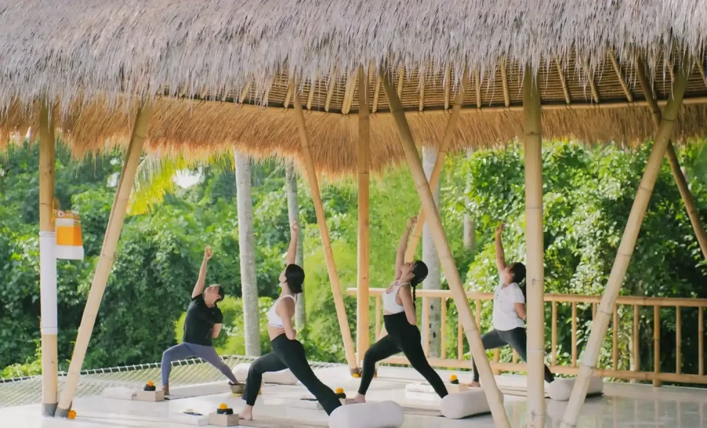 A morning yoga class in a bamboo pavilion