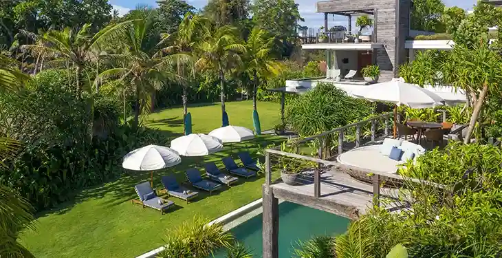A villa pool shaded by frangipani